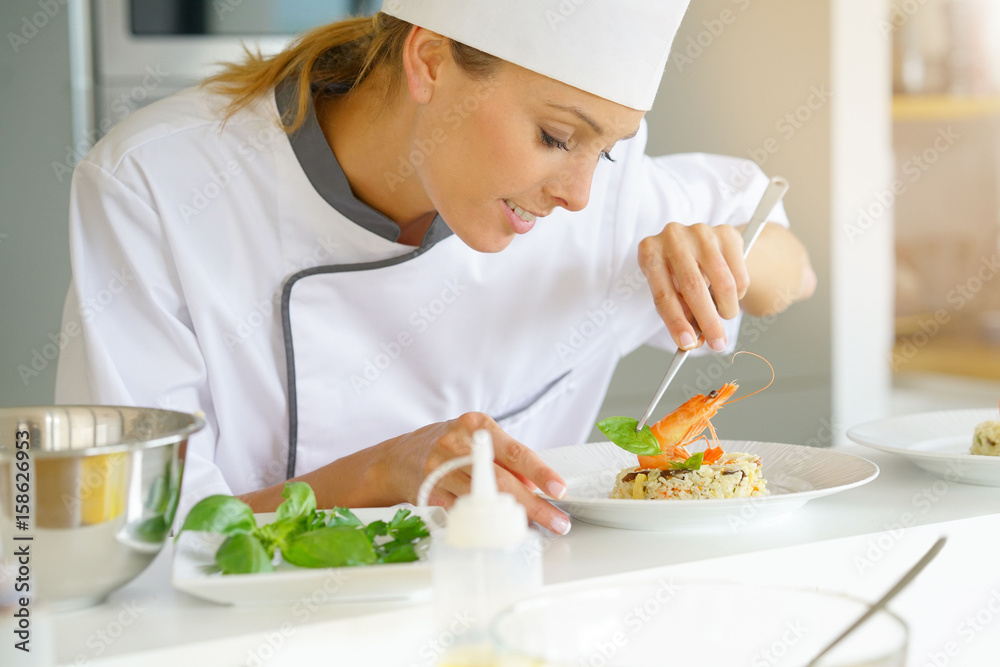 Chef preparing dish in professional kitchen Chef preparing dish in professional kitchen