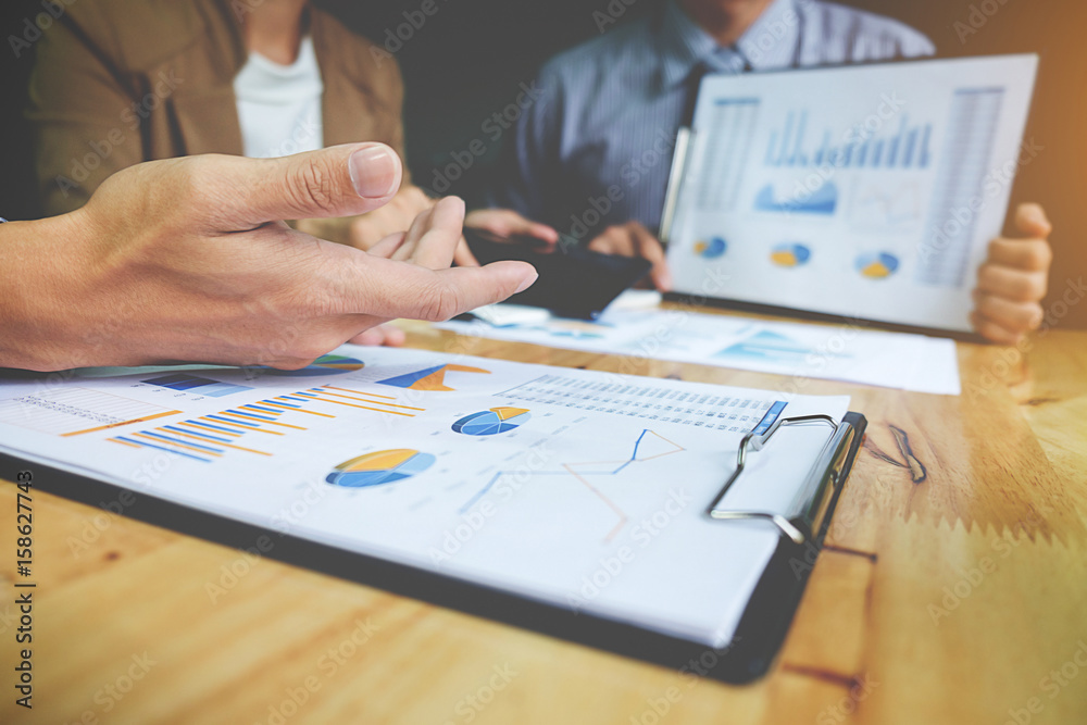 Business concept. Business people discussing the charts and graphs showing the results of their successful teamwork. Business concept. Business people discussing the charts and graphs showing the results of their successful teamwork.