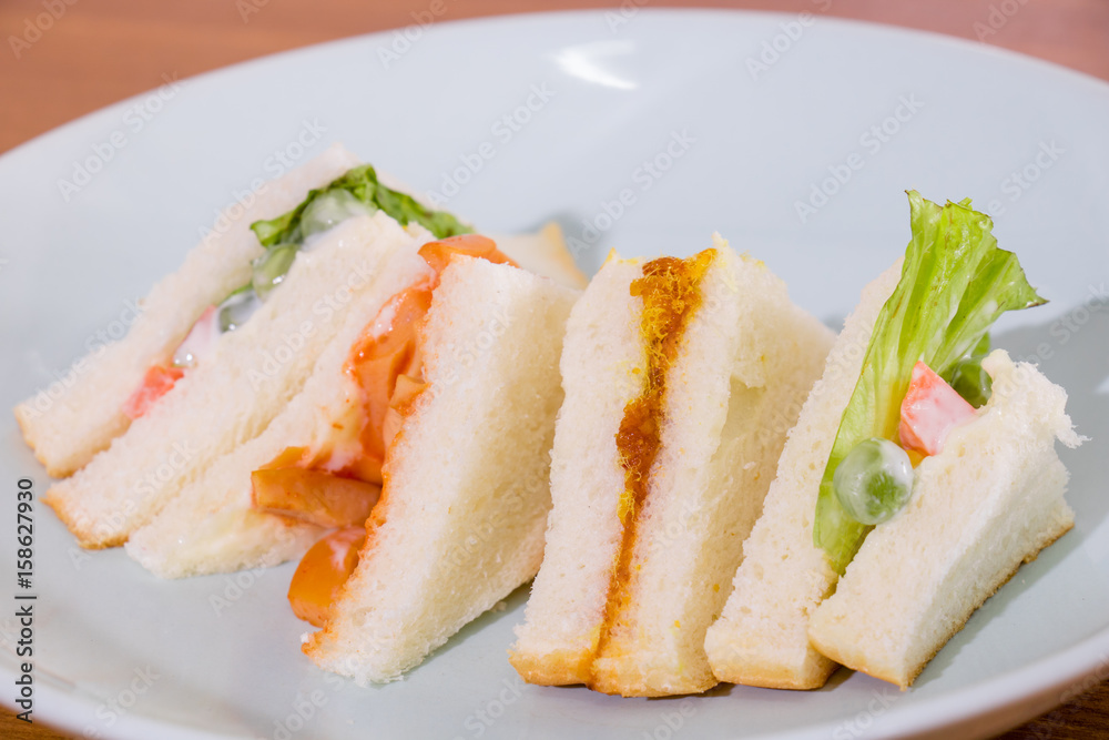 delicious sandwich with ham vegeable bread on white dish , home made sandwich, health food delicious sandwich with ham vegeable bread on white dish , home made sandwich, health food