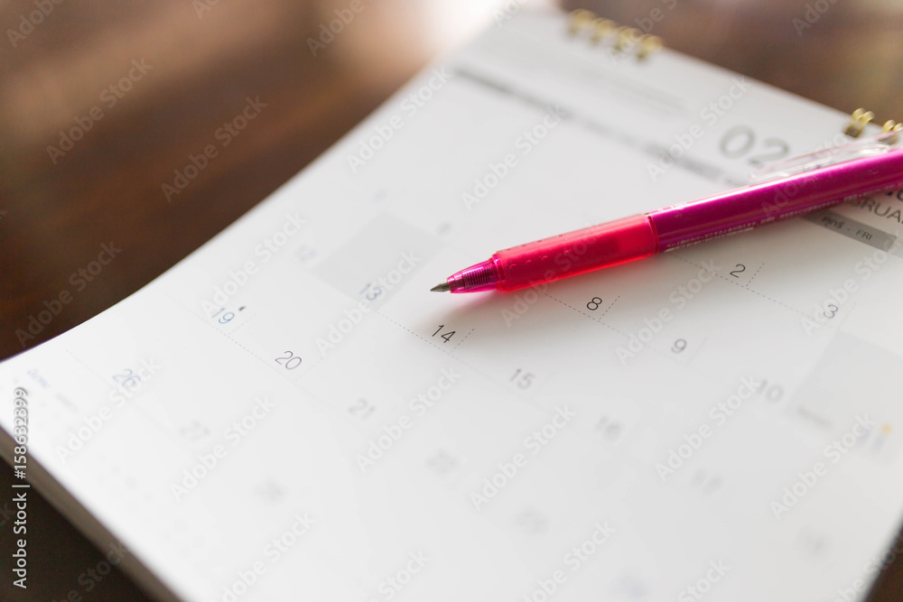 Blurred calendar opening on the page February. Focus the heart drawing on Feb 14 Blurred calendar opening on the page February. Focus the heart drawing on Feb 14