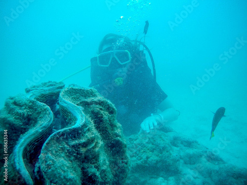 Woman scuba diver exploring underwater life in the deep blue ocean