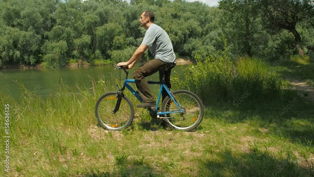 A sports family with bicycles on the background of the landscape. Cyclists by the river. A sports family with bicycles on the background of the landscape. Cyclists by the river.