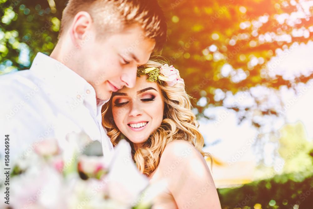 Fototapeta premium Pretty young wedding couple outdoor in the park