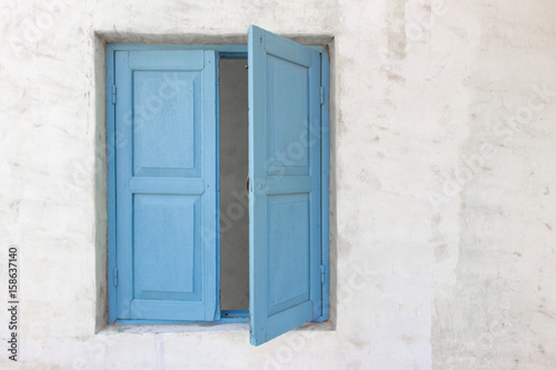Slightly open of blue wooden window