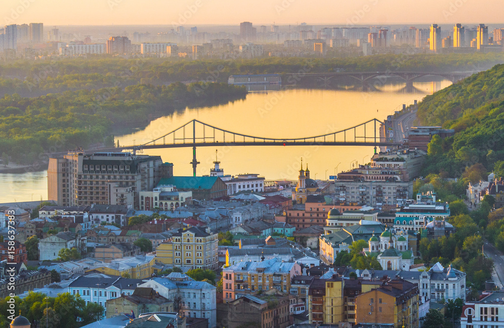 Dawn view from the height to the old town of Podol, from the Schekavitsa mountain in the background of the Ukrainian capital Kiev