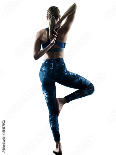 one caucasian woman exercising fitness Stretching excercises in silhouette isolated on white background