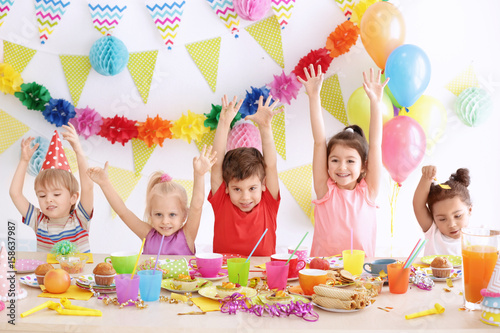 Cute little children celebrating birthday at party