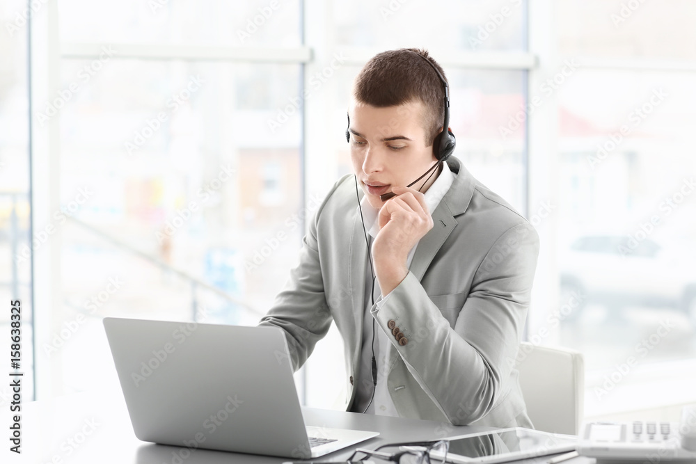 Fototapeta premium Handsome young man working in office