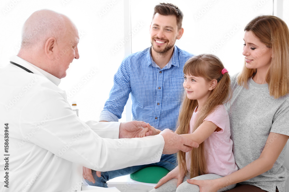 Little girl with parents at doctor's office