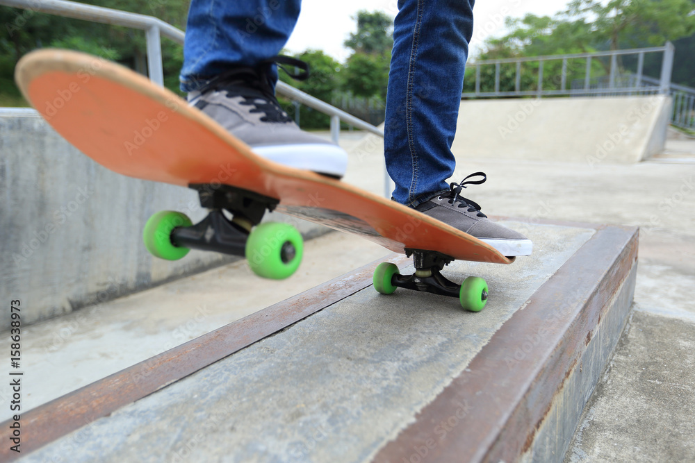 young woman skateboarder skateboarding at skatepark young woman skateboarder skateboarding at skatepark
