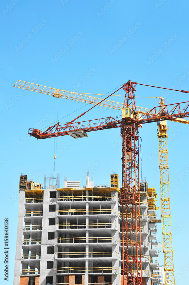 Crane and highrise construction site Crane and highrise construction site