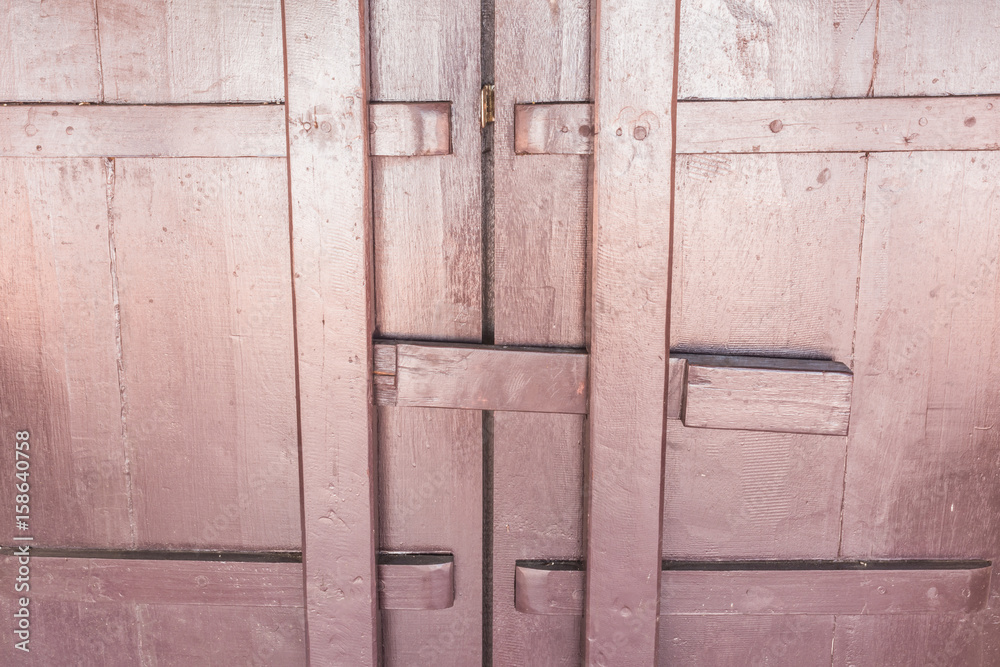 Closeup of old brown door on Thai temple, Asia.