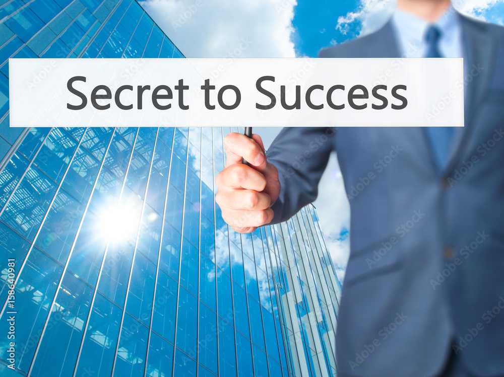 Secret to Success - Businessman hand holding sign Secret to Success - Businessman hand holding sign