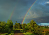 A rainbow over the Trans Canada Trail or the Confederation trail in rural Prince Edward Island, Canada.