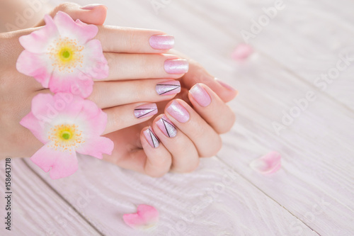 Beautiful pink manicure with silver triangles