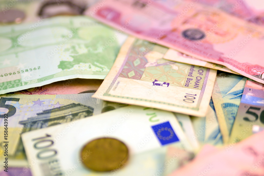 Different currency note and coins from different countries background Different currency note and coins from different countries background
