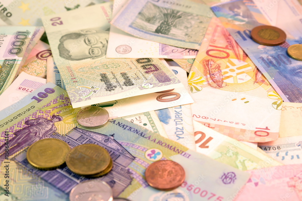 Different currency note and coins from different countries background ...