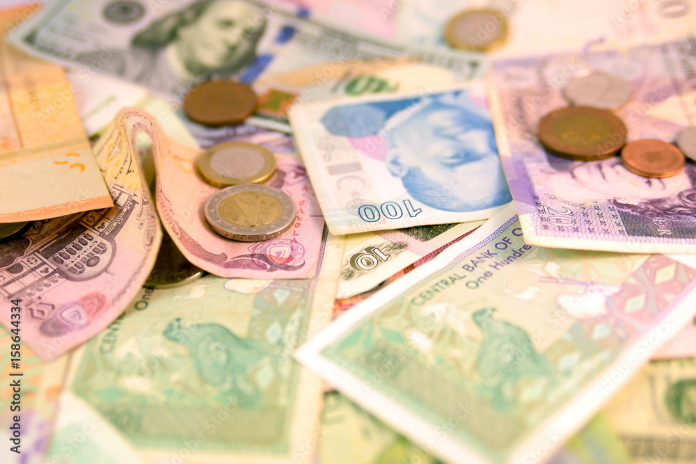 Different Devises Different currency note and coins from different countries background ...