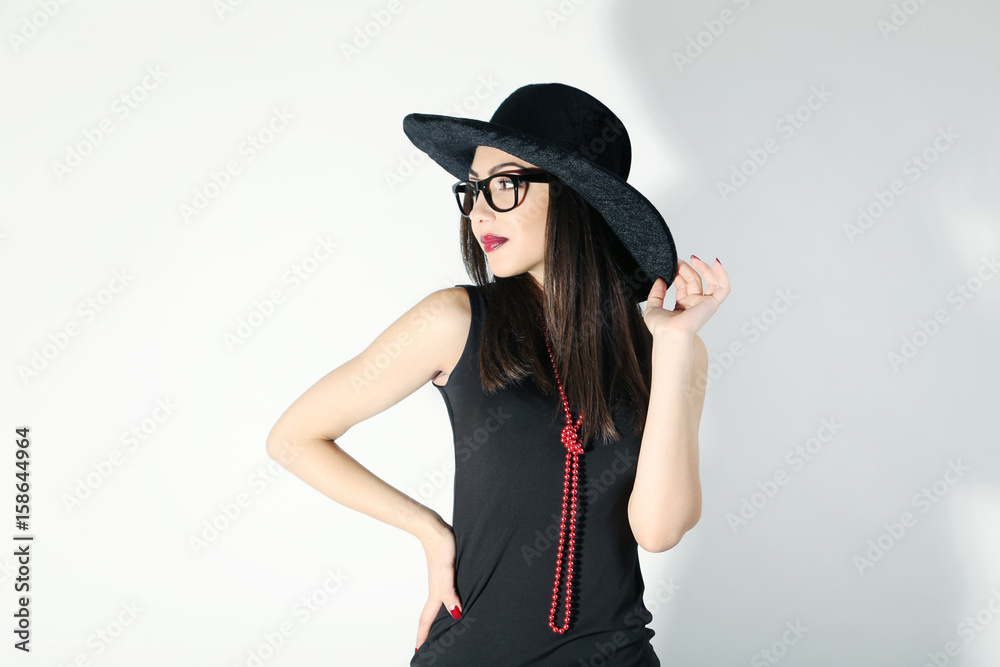 Young brunette woman in black dress on a white background Young brunette woman in black dress on a white background