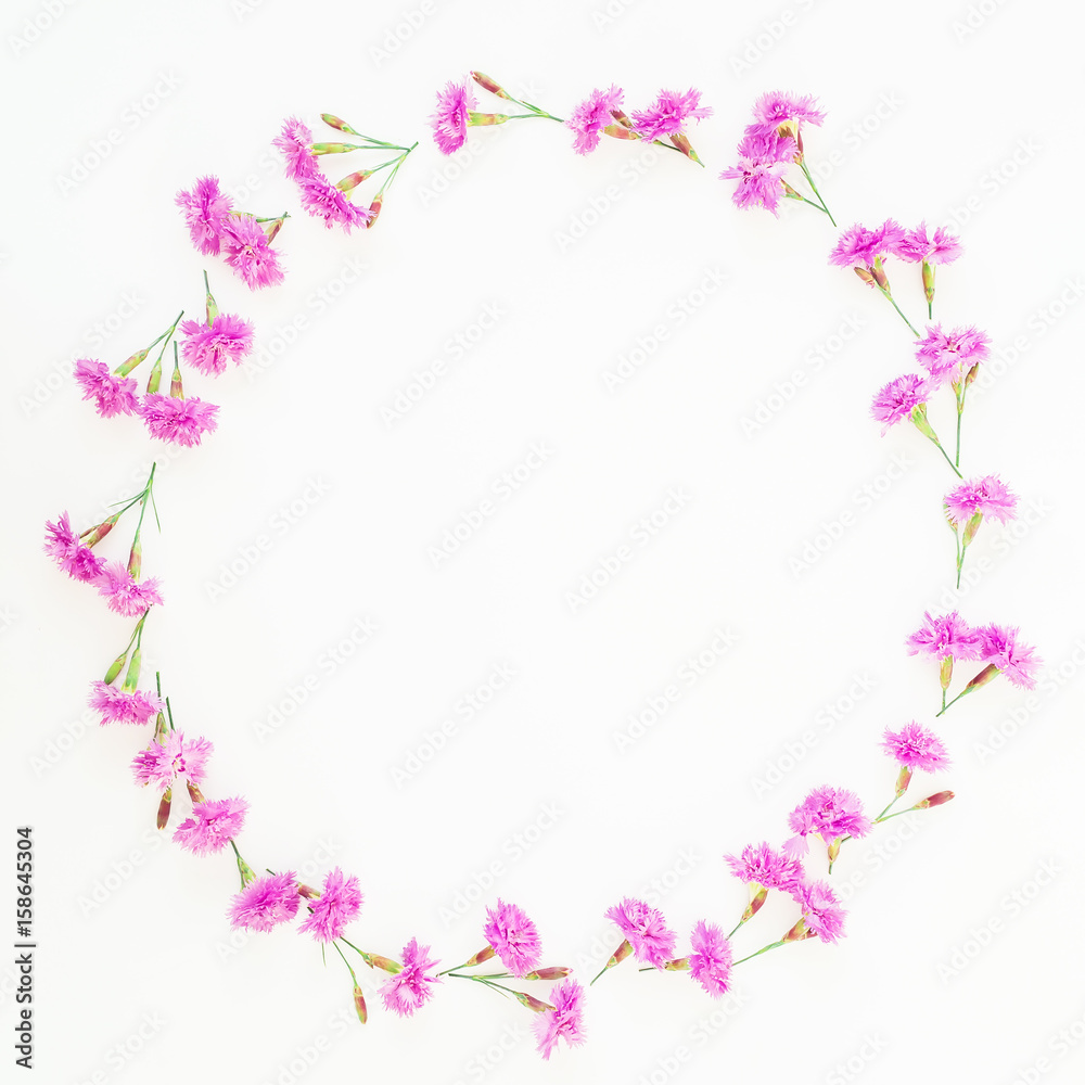 Frame wreath made of pink flowers on white background. Flat lay, top view. Floral pattern