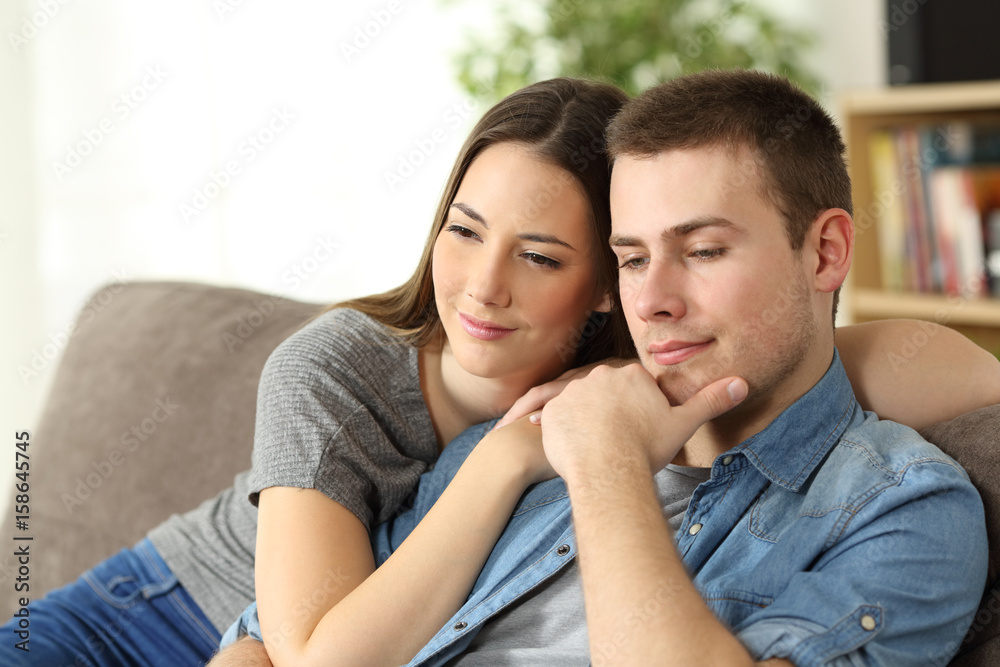 Pensive couple thinking at home Pensive couple thinking at home