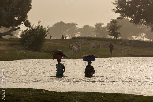 Silhouette of people on a river bank in Segou, Mali