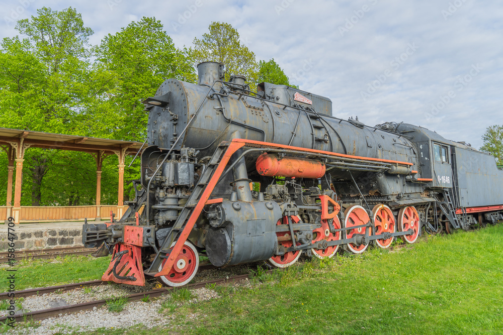 Naklejka premium Old steam locomotive train under blue sky