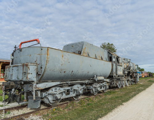Old steam locomotive train under blue sky
