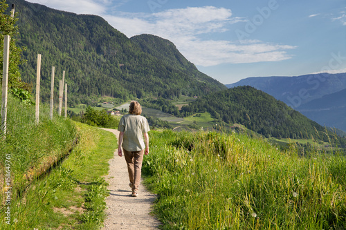 Frau beim Wandern auf einem Waalweg in Südtirol photo