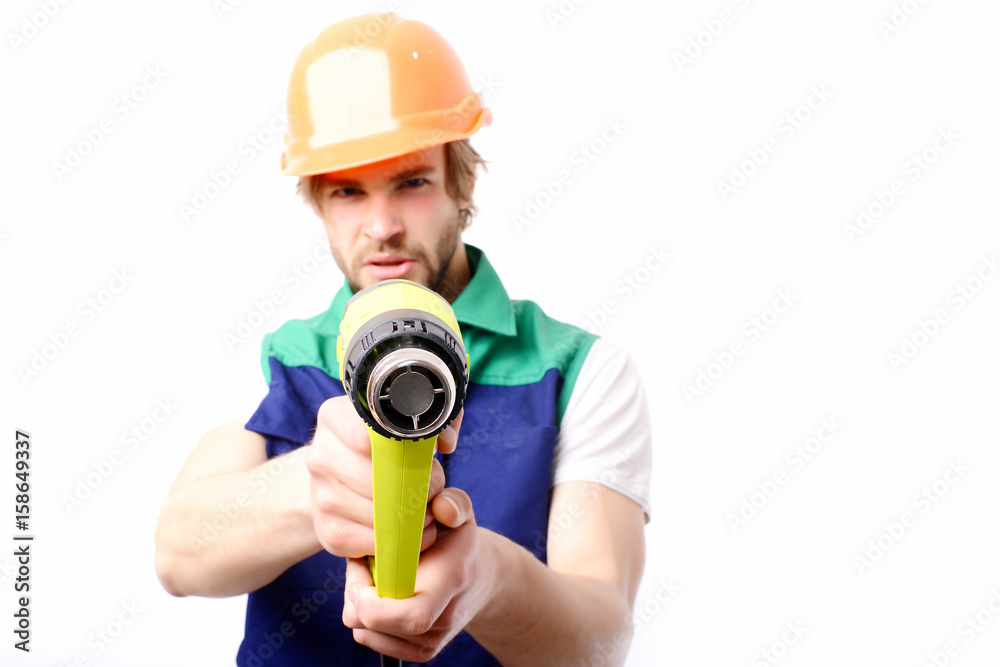 Builder with angry face expression holds yellow construction tool Builder with angry face expression holds yellow construction tool