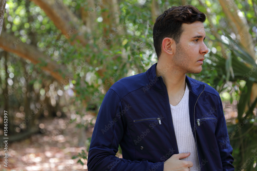 Man looking away from camera with unzipped jacket Man looking away from camera with unzipped jacket