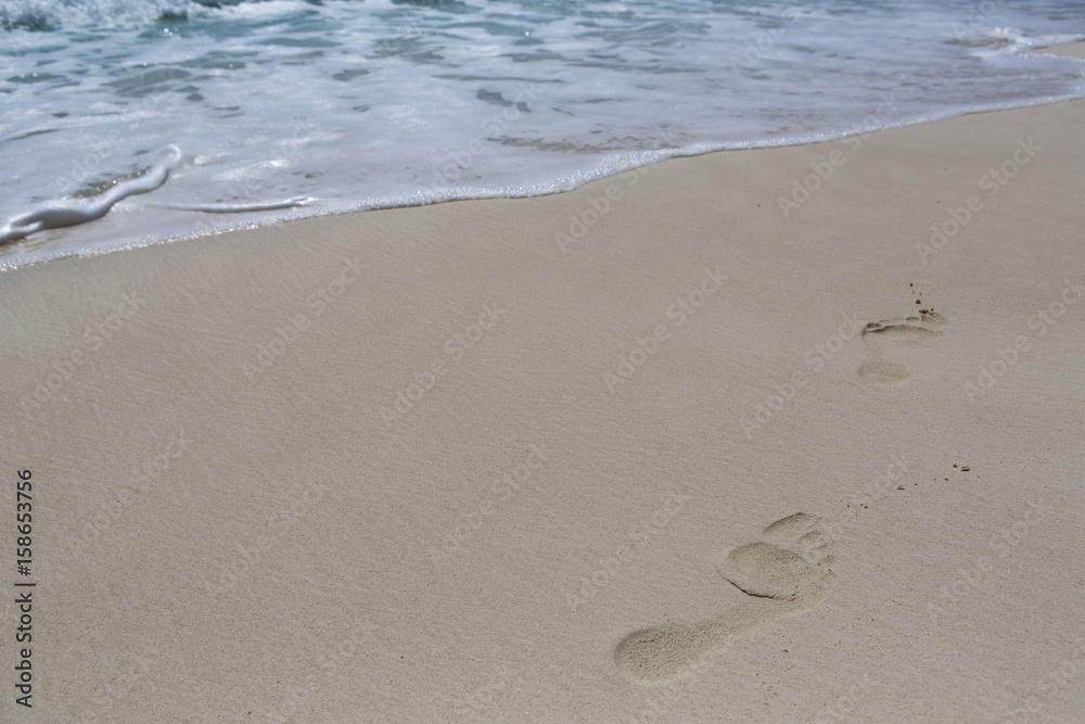 Footsteps on the beach. Footprints composed to the right side. Copy space. Footsteps on the beach. Footprints composed to the right side. Copy space.