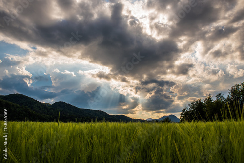 Sun rays penetrating the clouds over a beautiful landscape