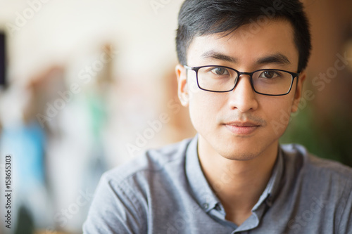 Confident Asian businessman in eyeglasses