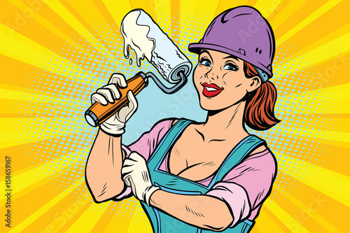 Construction worker with roller for paint. Woman professional