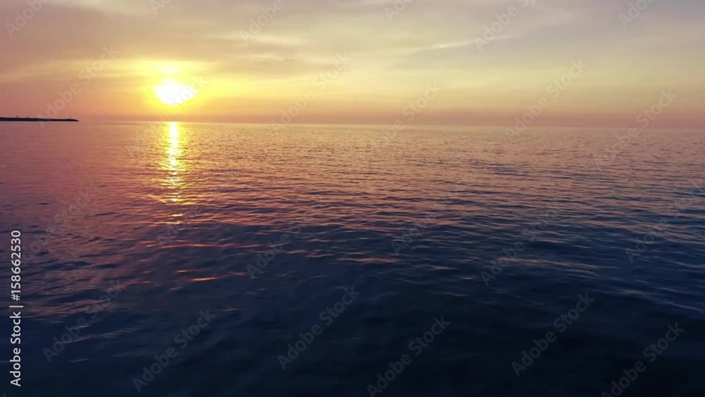 Shot of a beautiful summer sunset at the beach. Sunset at sea drone footage  