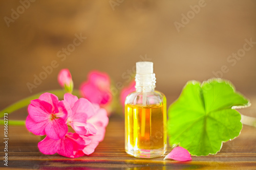 Essence of flowers on table in beautiful glass jar