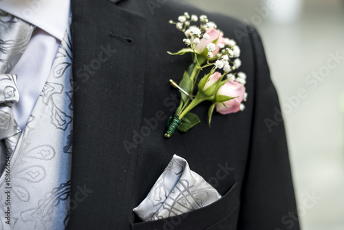 Fotografering Pink rose boutonniere flower groom wedding coat with tie shirt