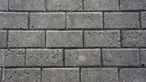 Gray brick stone road. Pavement texture photography.
