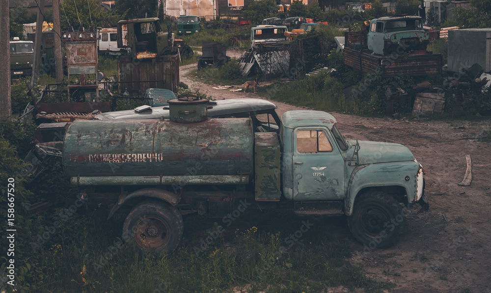 Rusty truck on the background of an abandoned factory.
