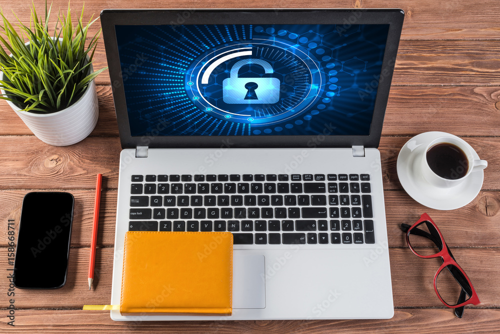 Web security and technology concept with laptop on wooden table Web security and technology concept with laptop on wooden table