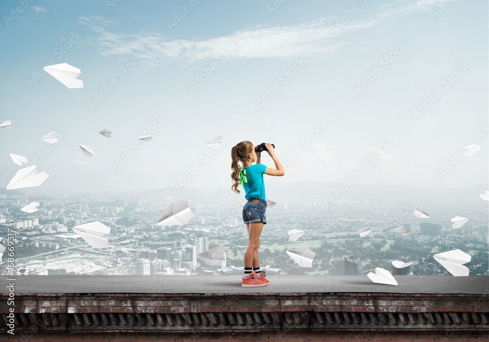 Concept of careless happy childhood with girl of school age looking in future Concept of careless happy childhood with girl of school age looking in future