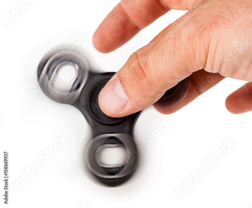 Palying with a Black Fidget Spinner