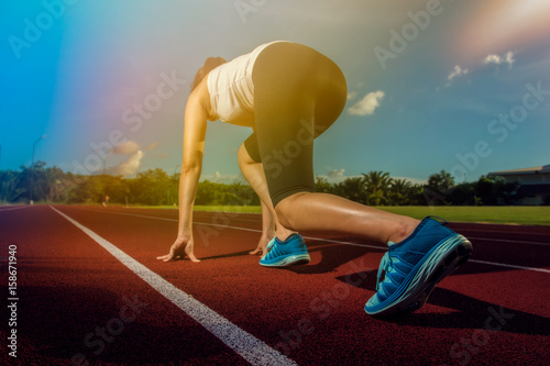 Sport Runner woman on stadium track. Fitness and workout wellness concept.