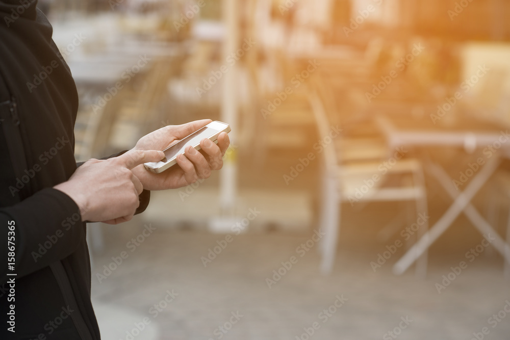 Obraz premium Man holding a smartphone and using it
