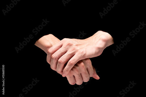 Male hands on a black background.