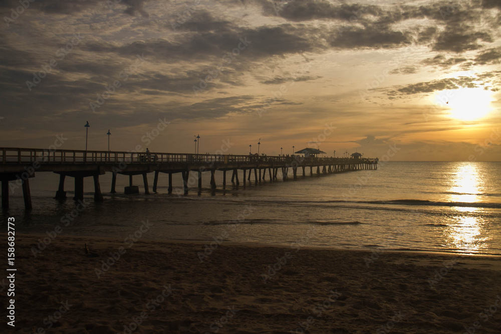 Long pier on sunrise beach