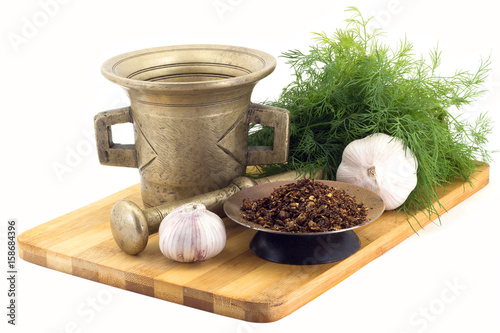 Composition of spices,Dried tomatoes , dill, garlic, vintage spice grinder isolated on white background photo