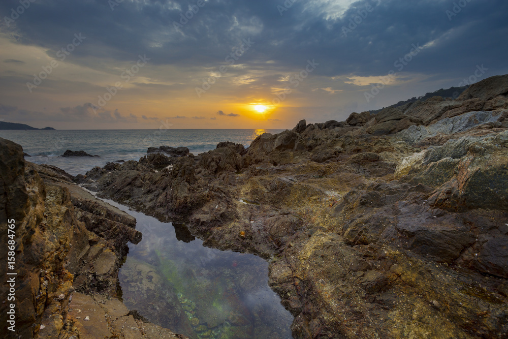 Fototapeta premium Seascape with rock in beautiful sunset scenery background.
