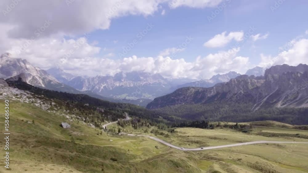 Aerial flight above mountain roads in sunny day. Summer adventure journey in mountain nature outdoors. Travel exploring Alps, Dolomites, Italy. 4k drone forward video Aerial flight above mountain roads in sunny day. Summer adventure journey in mountain nature outdoors. Travel exploring Alps, Dolomites, Italy. 4k drone forward video